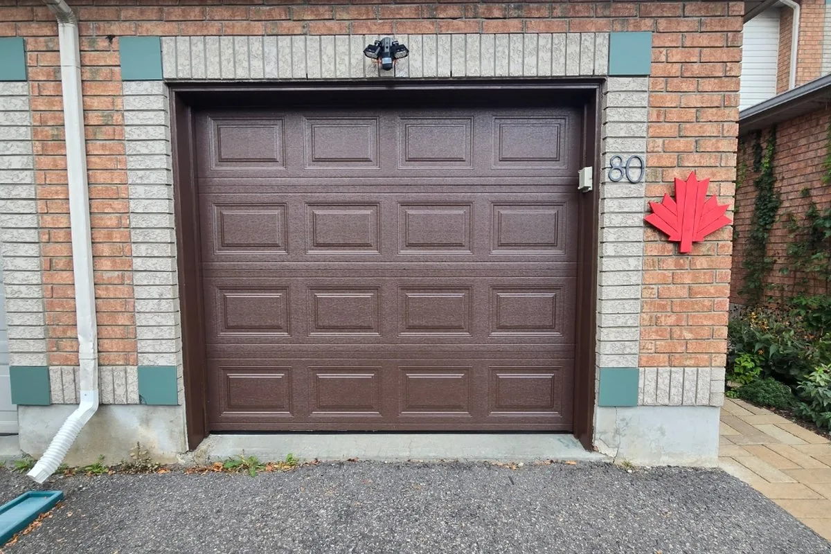 Centrepointe family home with attached single-car brown garage door