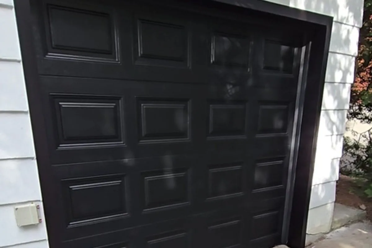 Modern Canadian home with a brand new flush dark insulated double garage door