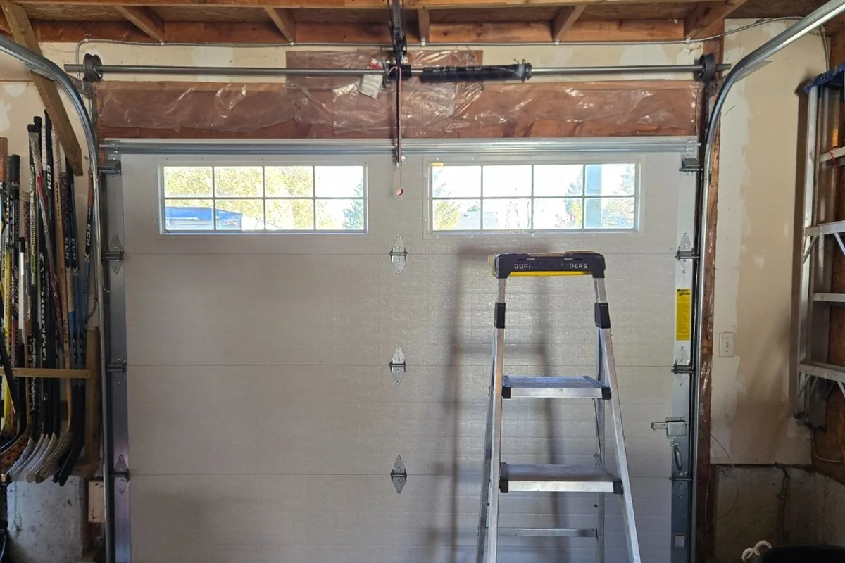 Clean modern belt-drive garage door opener mounted on a finished garage ceiling